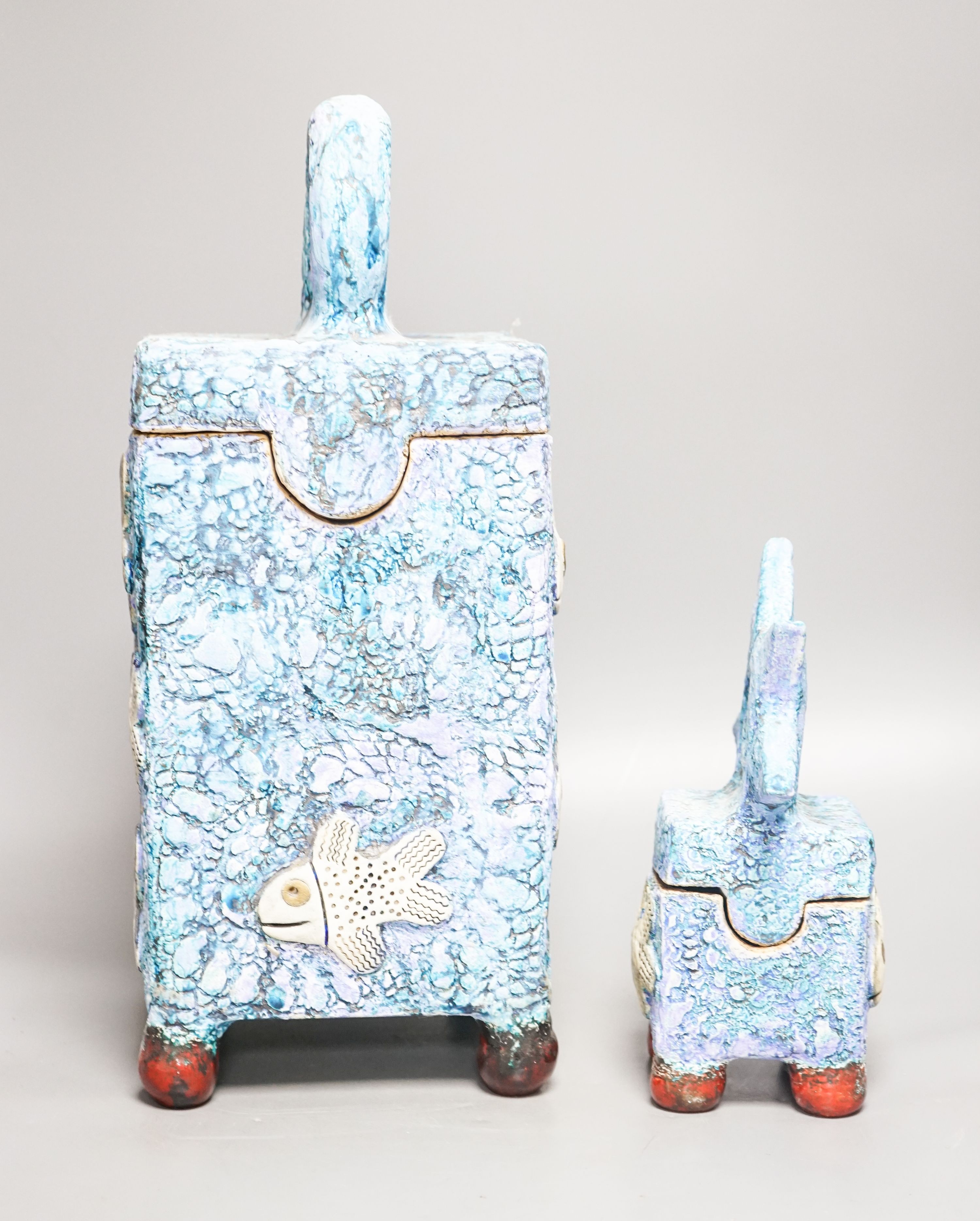 Gio Martin, a large square 'fish' jar and cover and a similar smaller jar and cover 44cm
